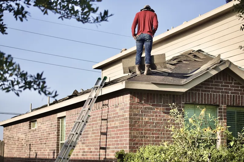 Professional roofer working on a residential roof in New Braunfels